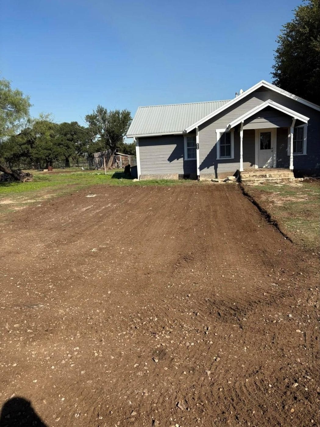 Freshly graded dirt in front of a house