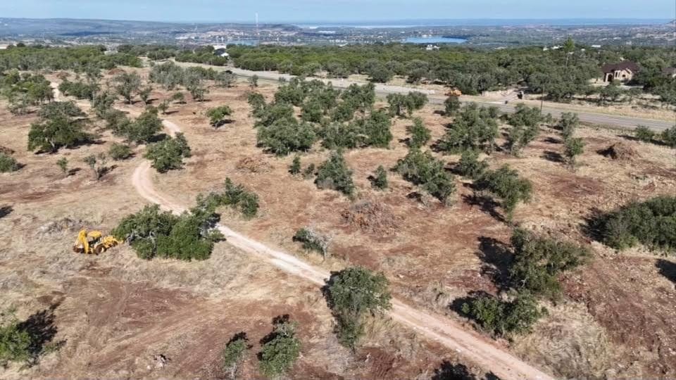 Drone view of land clearing in progress with a loader on site