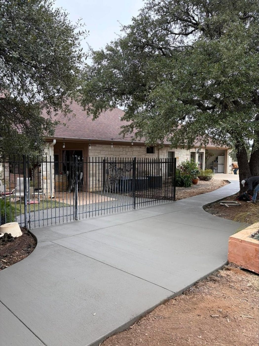New concrete walkway at a stone house